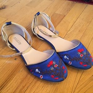Blue embroidered flats with gold ankle strap